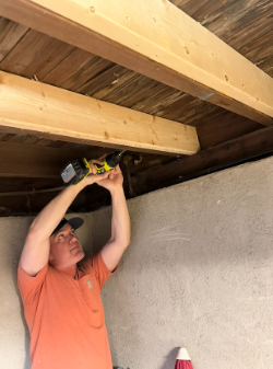 Replacing basement rafters for better security and stability.
